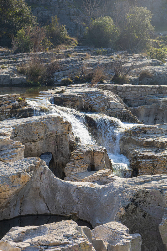 Bloc de calcaire creusé et cascade encaissée à la cascade du Sautadet, paysage minéral dominé par les rochers