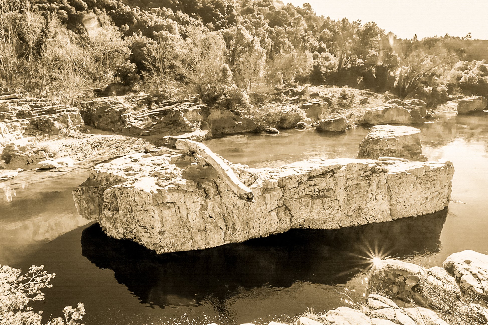 Rocher allongé sur la Cèze avec tronc et reflets, entouré de berges rocheuses et de végétation, vintage