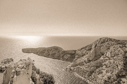 Éperon rocheux avançant dans la mer scintillante au large des calanques de Marseille, vintage