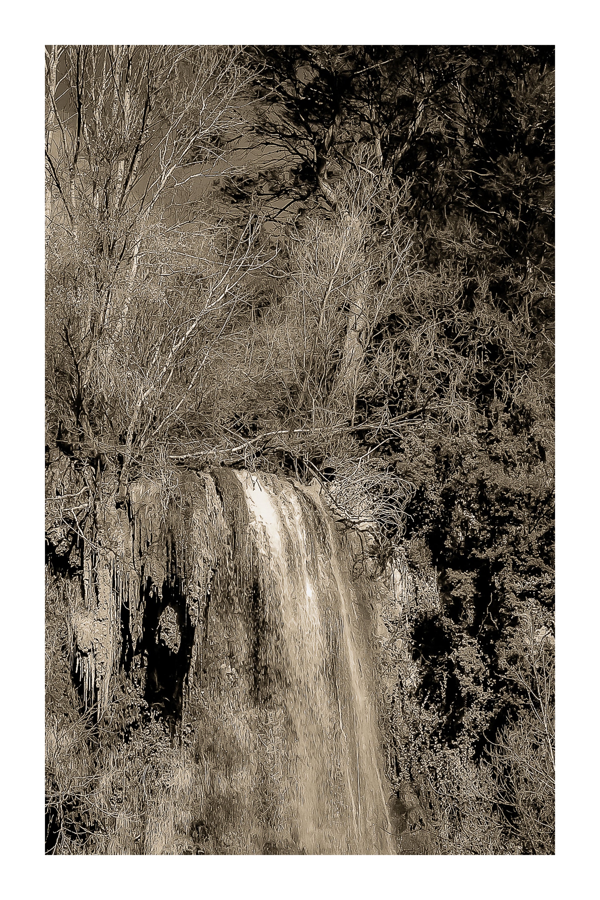 Gros plan vertical sur la cascade de Sillans avec eau ruisselante et mousses vertes accrochées à la falaise, vintage avec bordure