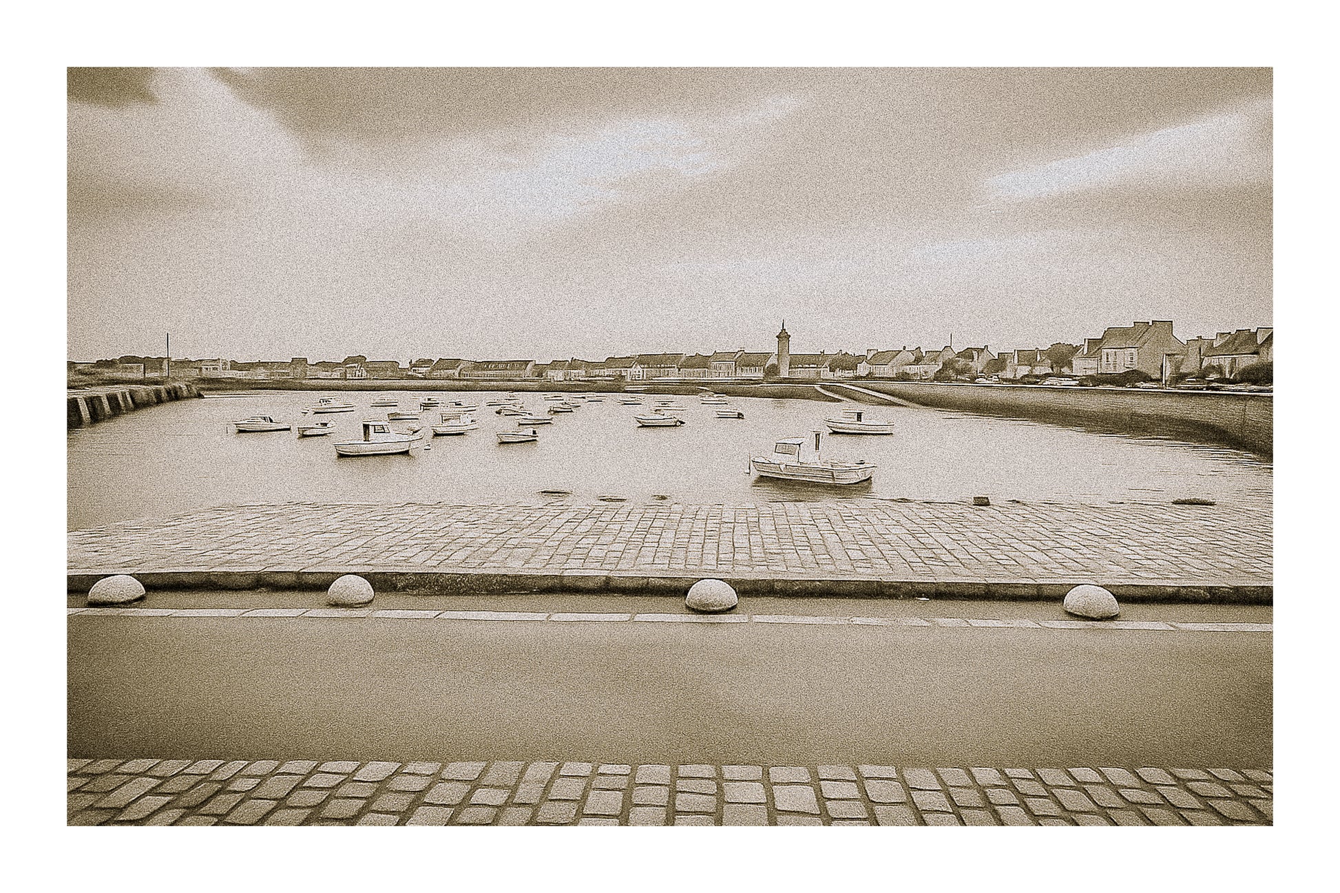 Port de Roscoff en traitement sépia avec bordure, pavés au premier plan, barques au mouillage et môle au loin